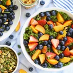 Fresh summer peach and blueberry kale salad in a bowl